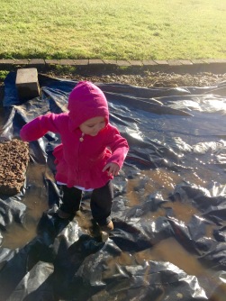 I took too long pulling one stubborn weed, and of course she found some lovely puddles.