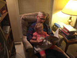 My dad in his element, reading to his granddaughter.
